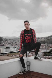 Young person customizing an oversized t-shirt on a digital platform with vibrant urban graphics.