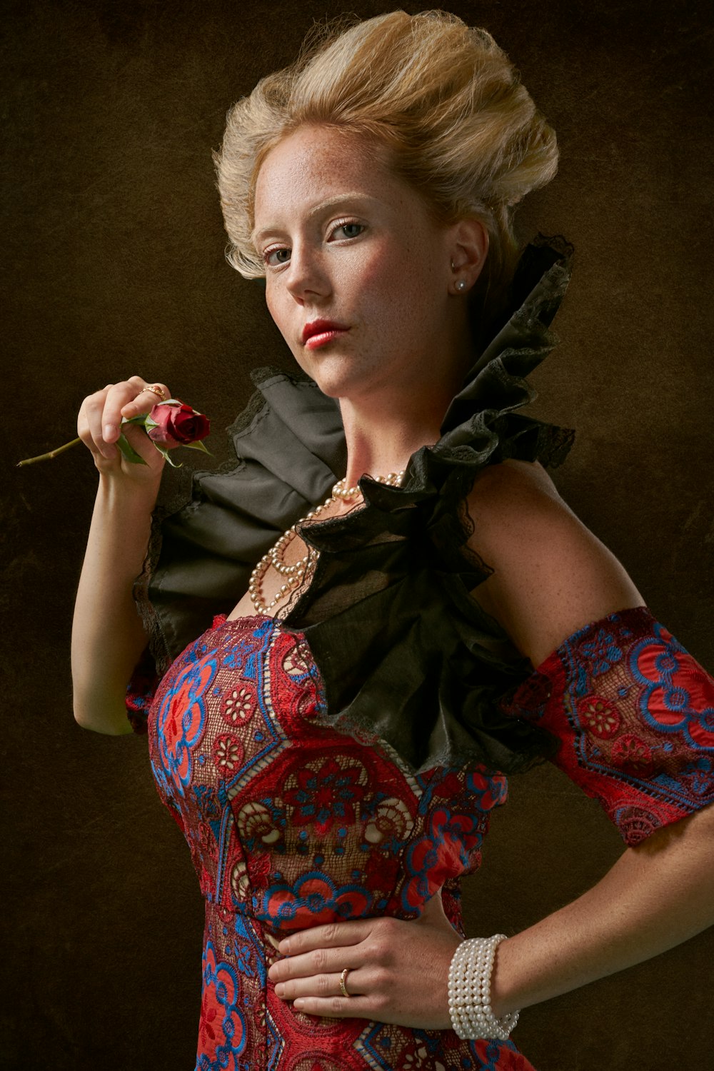 woman wearing red, blue, and white floral jaboot-neckline dress