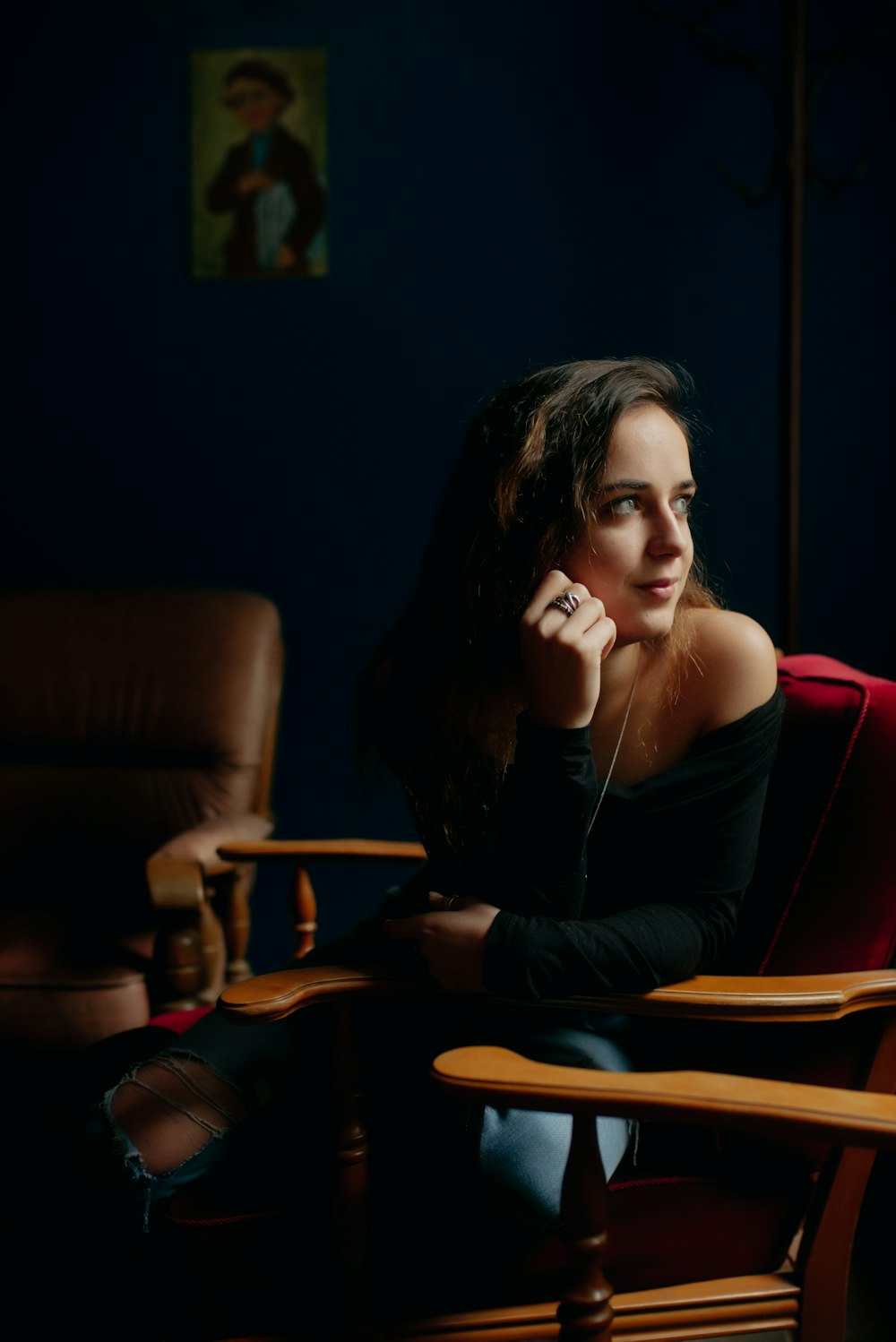 a woman sitting in a chair talking on a cell phone