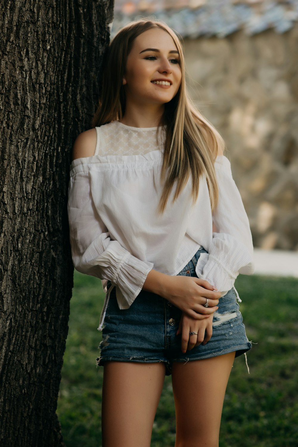 woman leaning on tree