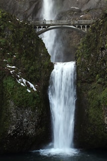 gray bridge over water falls