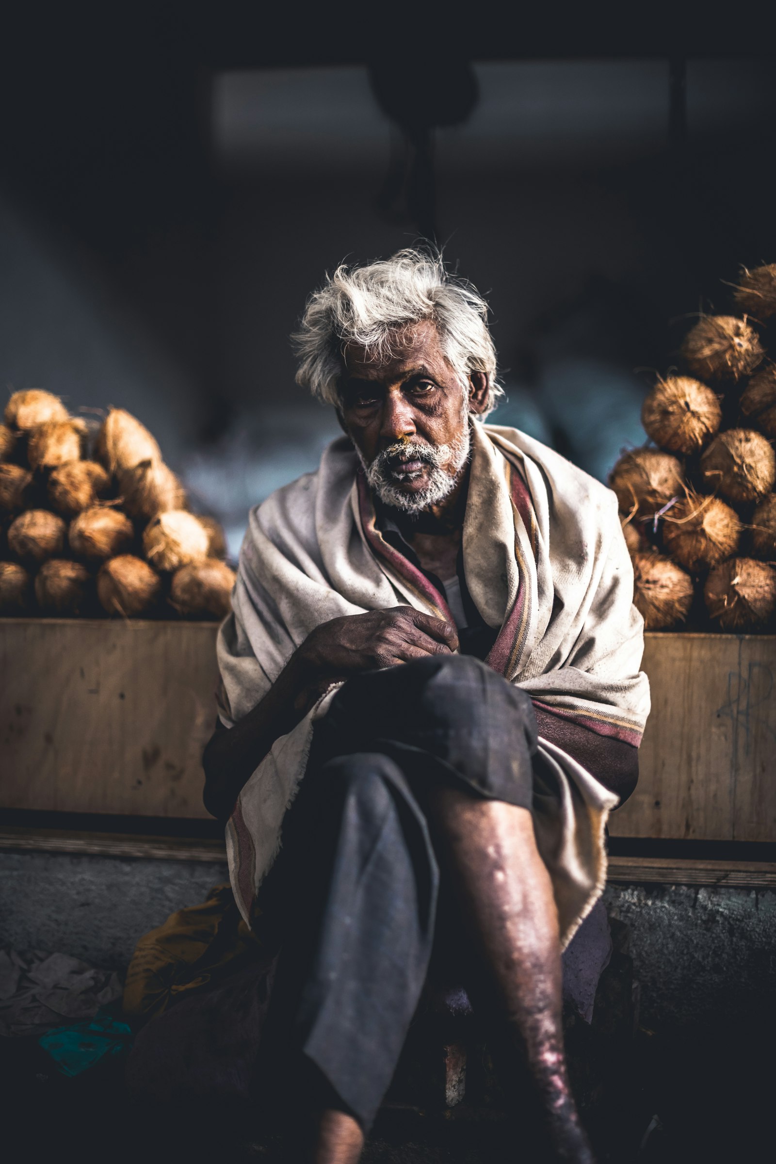 Nikon D850 + Nikon AF-S Nikkor 50mm F1.4G sample photo. Man sitting beside coconut photography