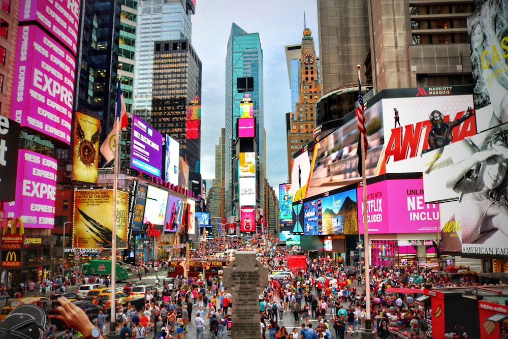 a crowded city street filled with lots of tall buildings