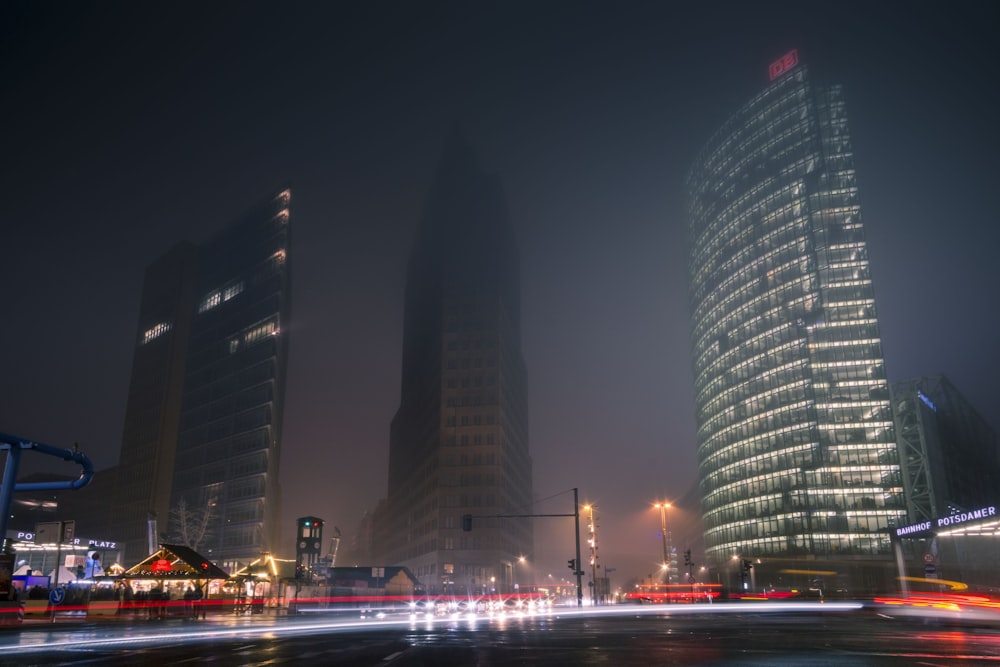 three gray high-rise buildings at night time