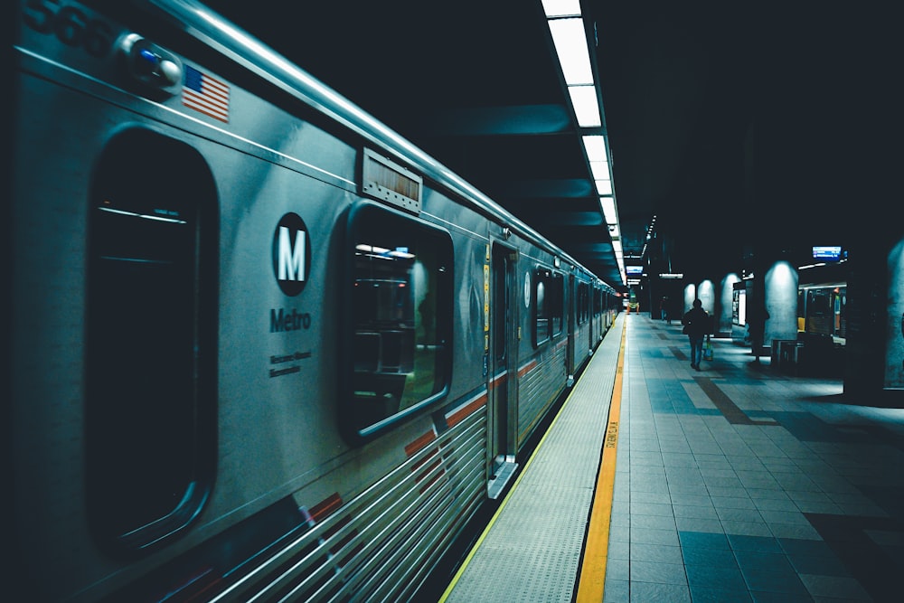 person walking beside train