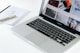 Macbook Pro besides white book