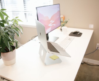 MacBook Pro placed on brown table