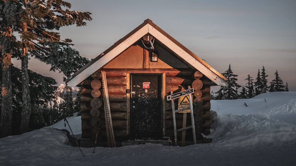 brown wooden house in the middle of icy surface