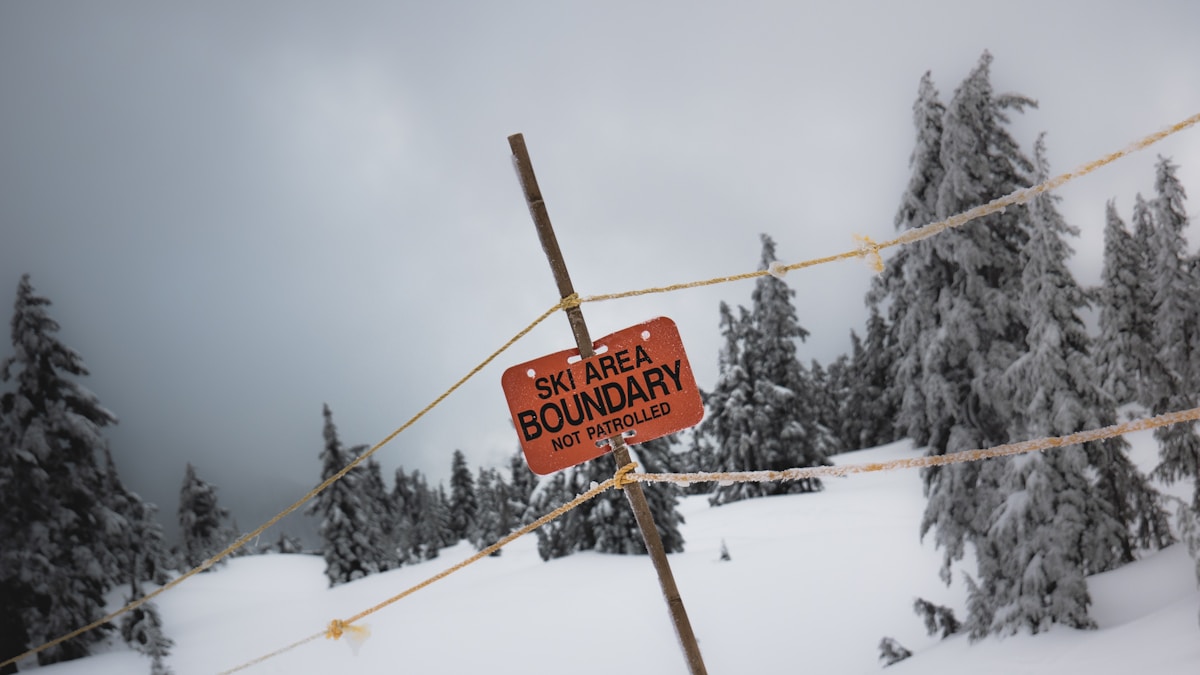 Ski Area Boundary sign on a snowy mountain slope