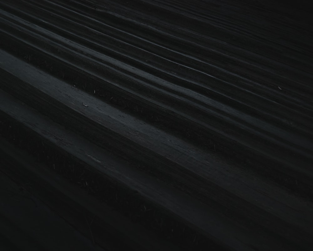 a black and white photo of a street at night