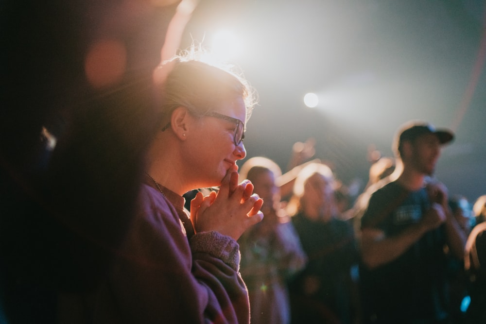 selective focus photography of woman praying