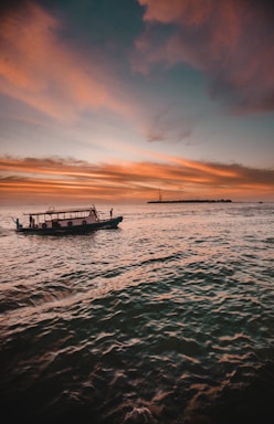 white and green power boat surrounded by body of water
