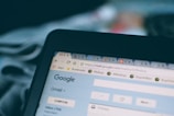 A computer screen displaying a web browser with multiple open tabs, including one for Gmail showing part of the interface and inbox. The focus is on the top section of the browser window, visible tabs, and the URL bar.