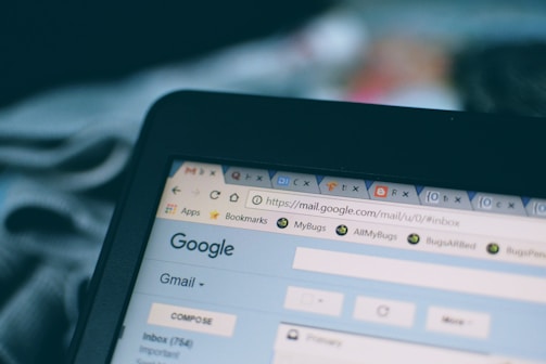 A computer screen displaying a web browser with multiple open tabs, including one for Gmail showing part of the interface and inbox. The focus is on the top section of the browser window, visible tabs, and the URL bar.