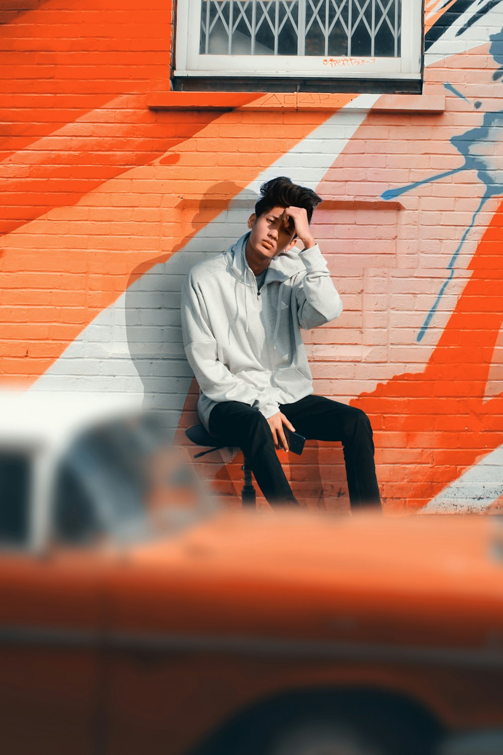 selective focus photography of man sitting black armless chair