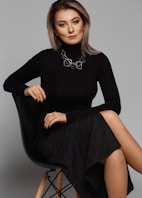 woman sitting on black chair