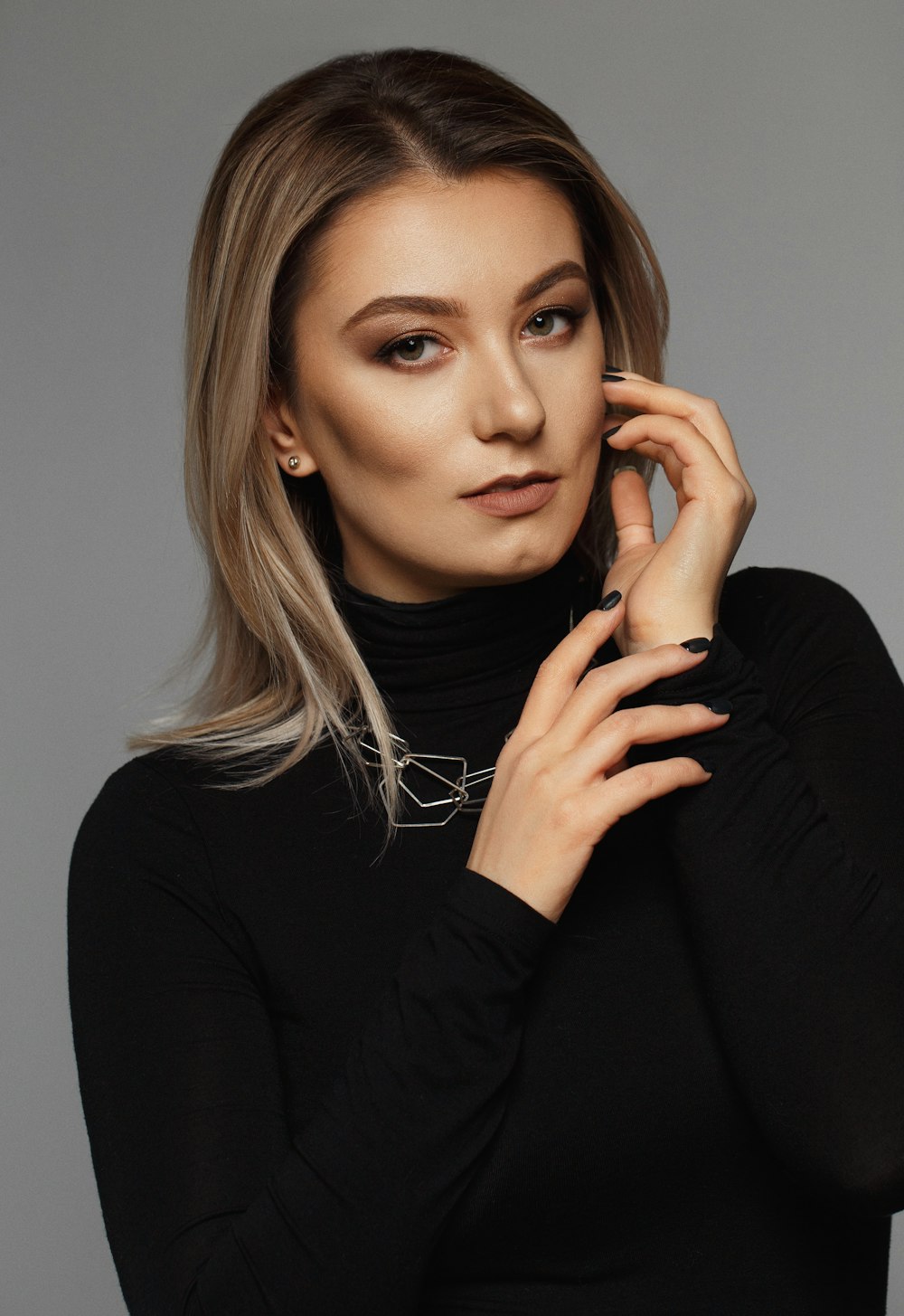 selective focus photography of woman in black turtle-neck long-sleeved shirt