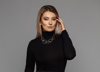 woman wearing black turtleneck long-sleeved dress