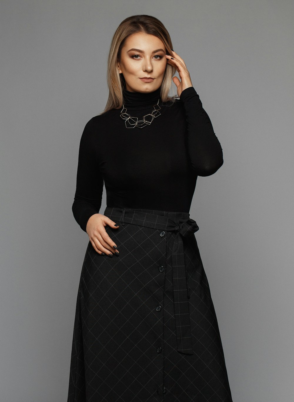 woman wearing black turtleneck long-sleeved dress