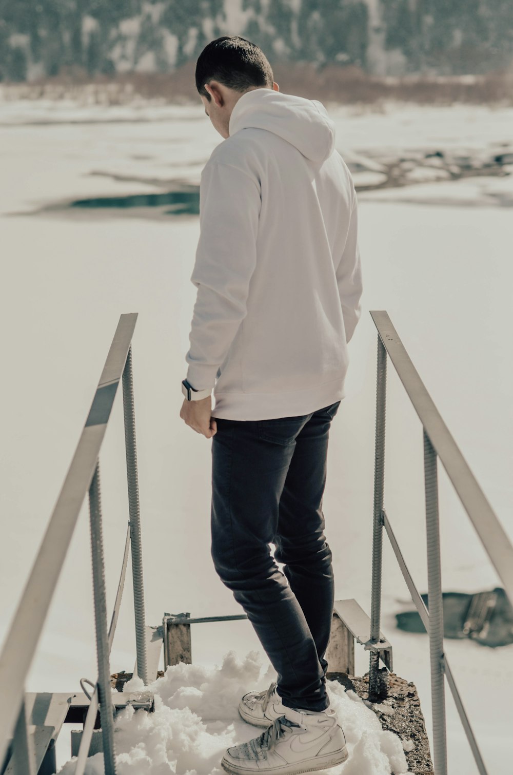 selective focus photography of man standing on snowfield during daytime