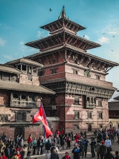 group of people standing near brown and black concrete gazebo