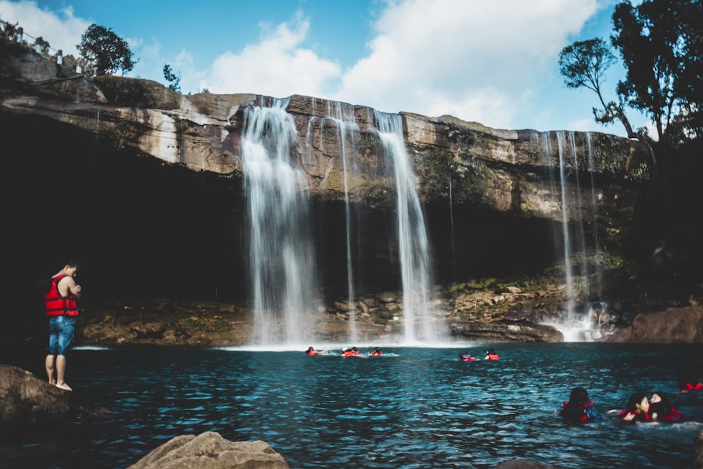 people in waterfalls