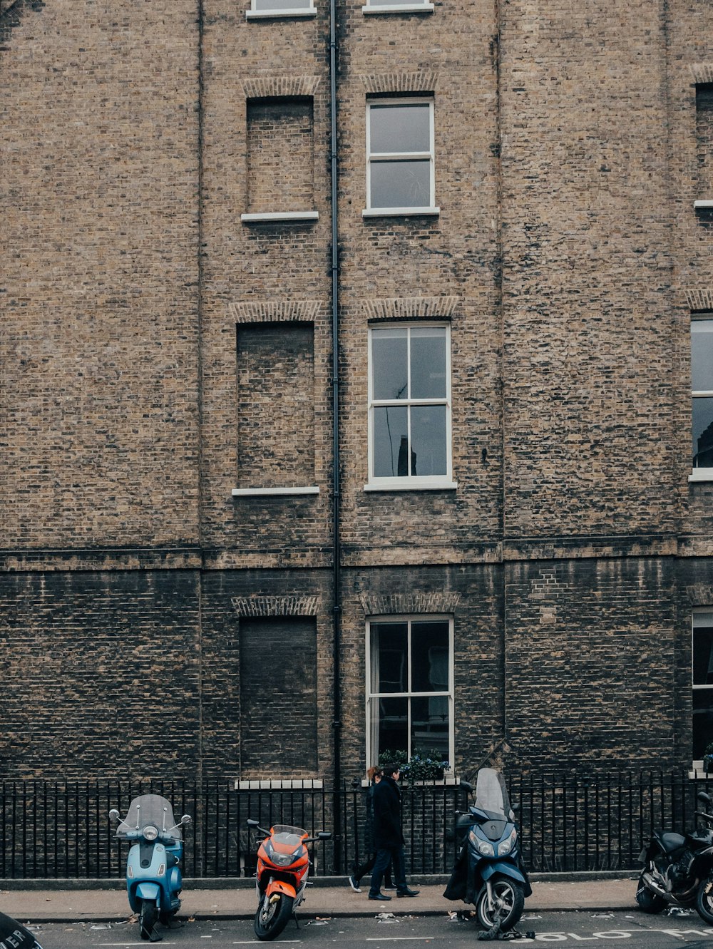 motorcycles parked in front of bricked building at daytime