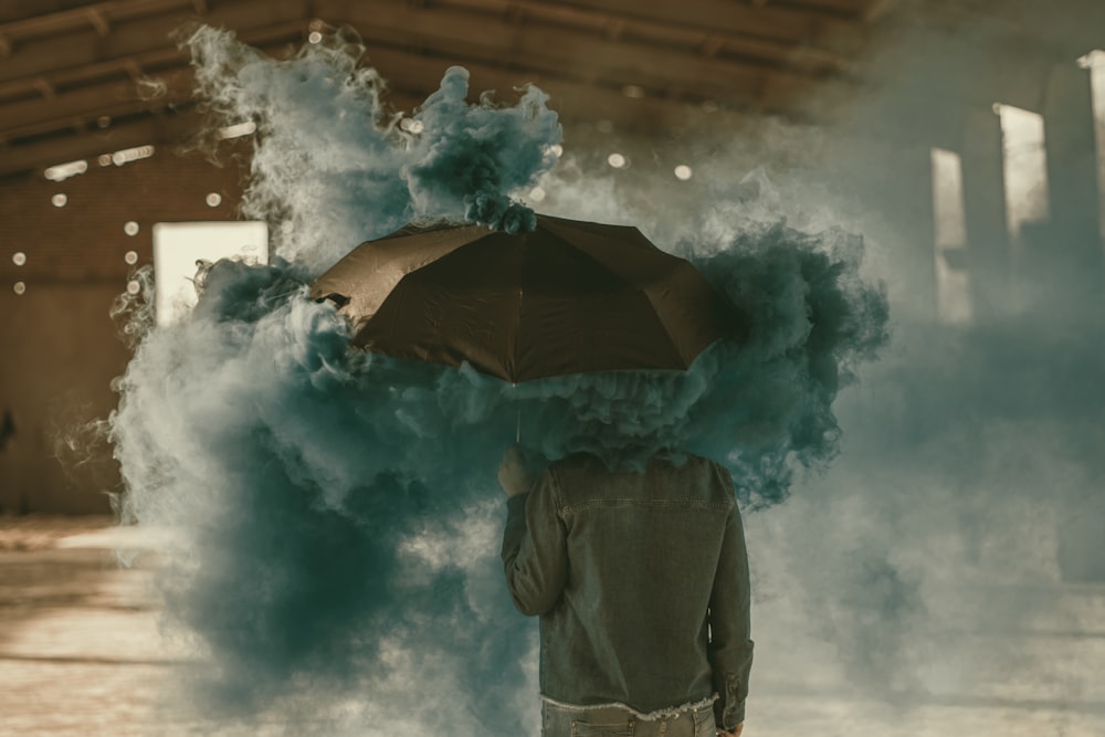 person standing near building with green smokes