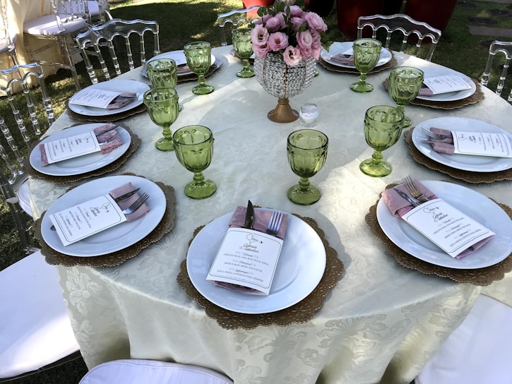 A beautifully arranged square table set for an outdoor event in Riyadh.