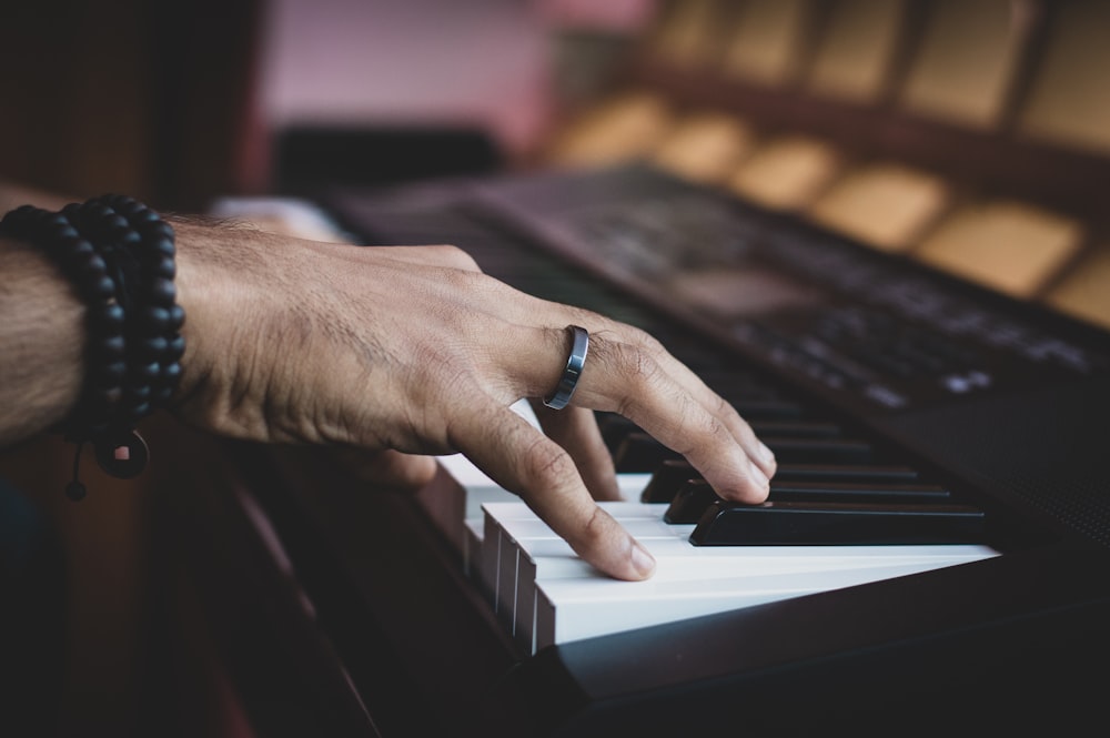 person playing on electronic keyboard