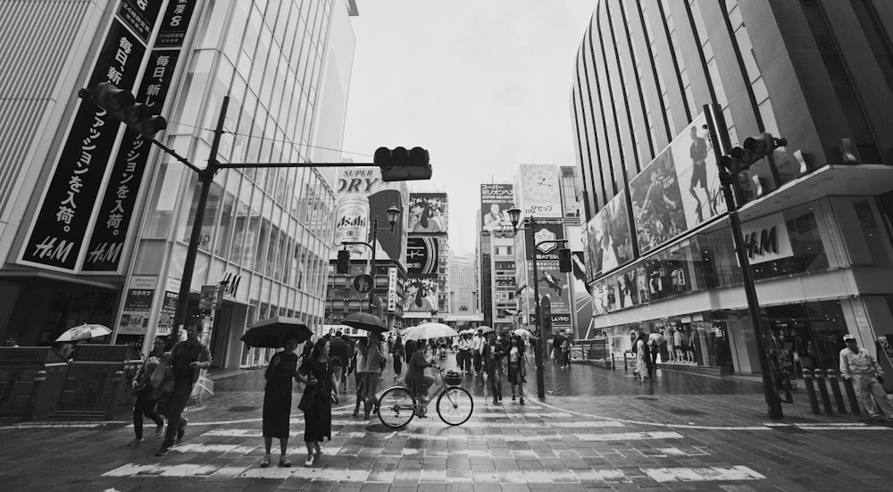 grayscale photography of city roads with people