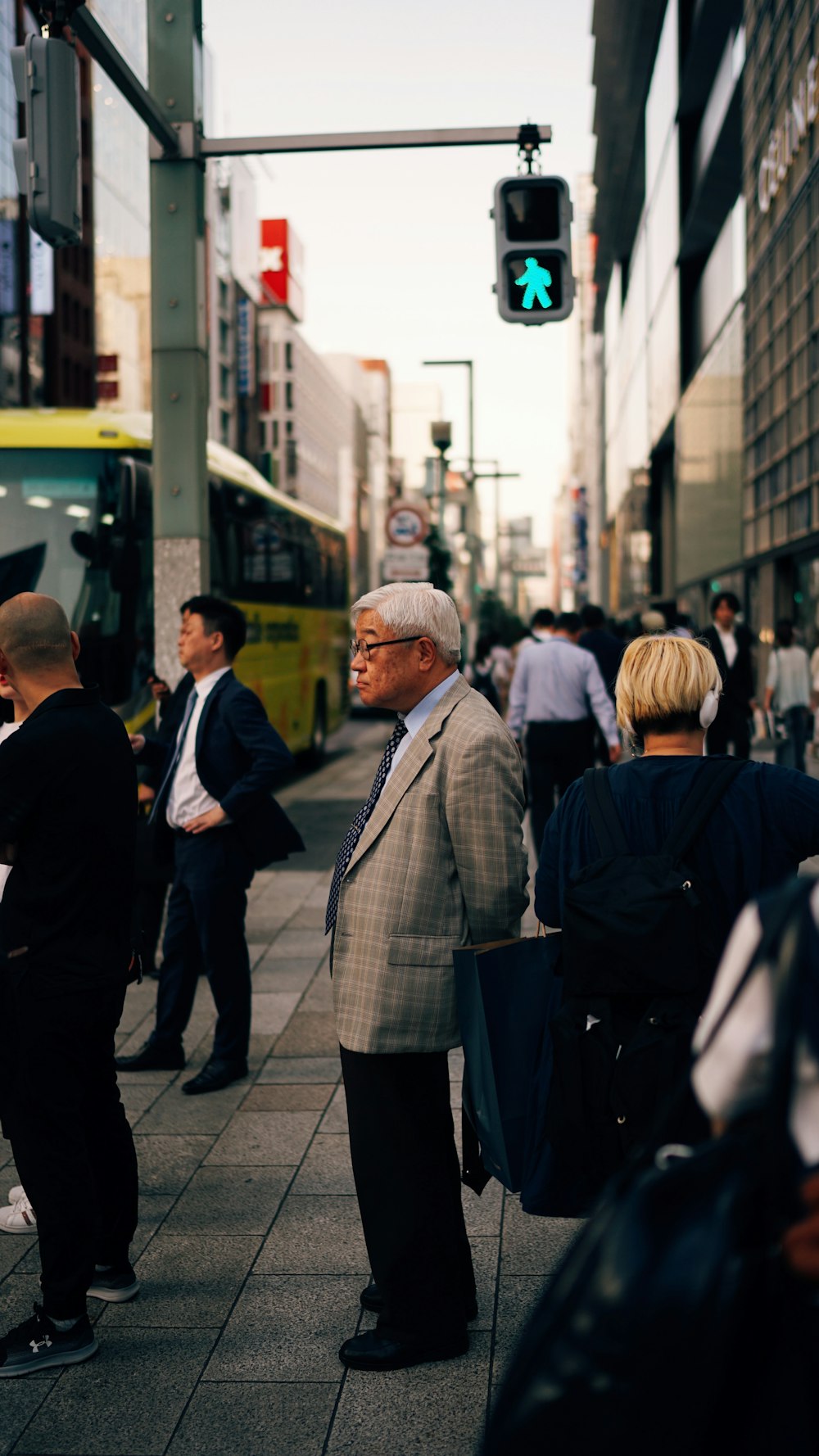 man in gray suit standing near traffic light