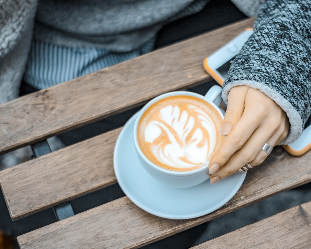 person holding white ceramic mug