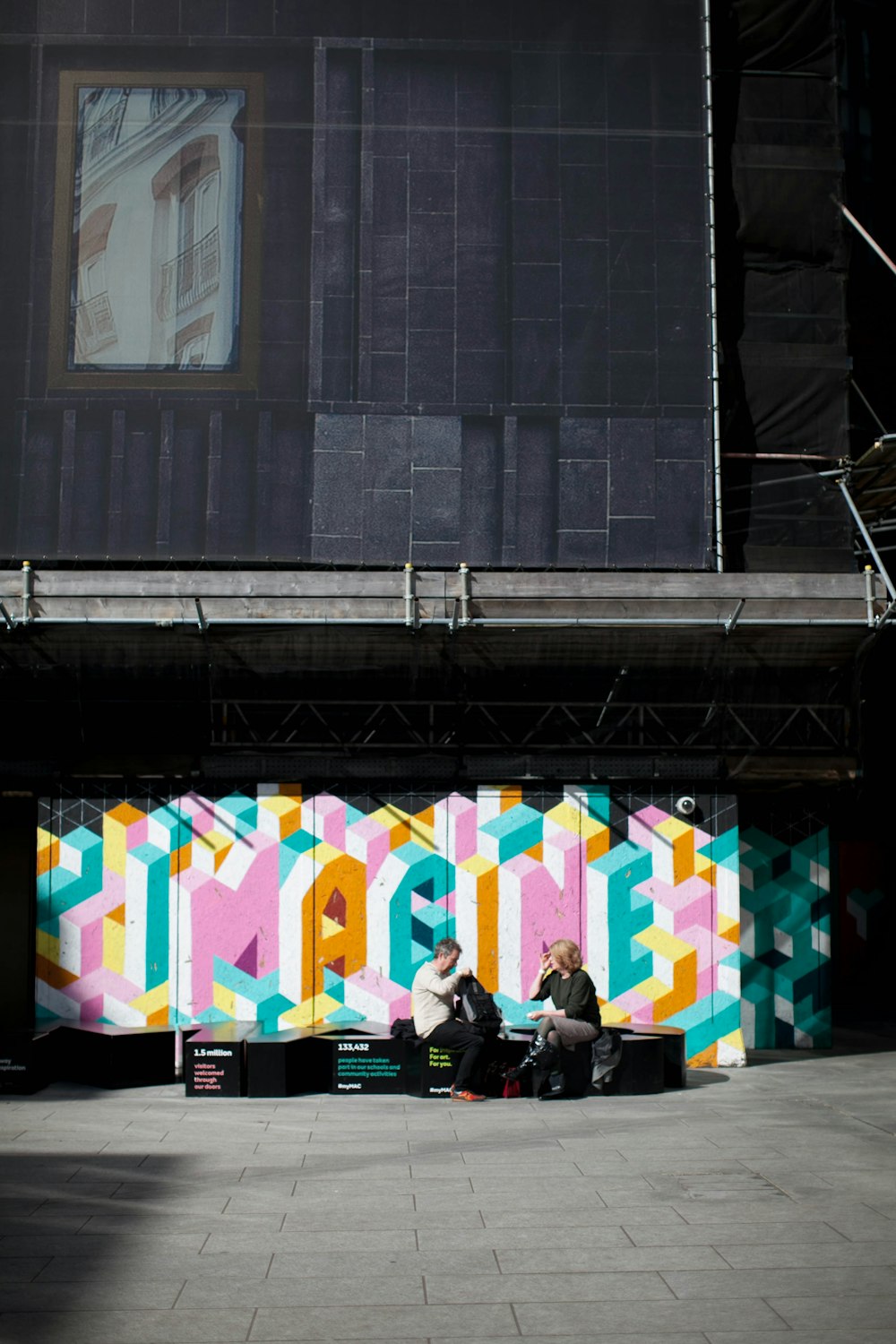 man and woman sitting on bench