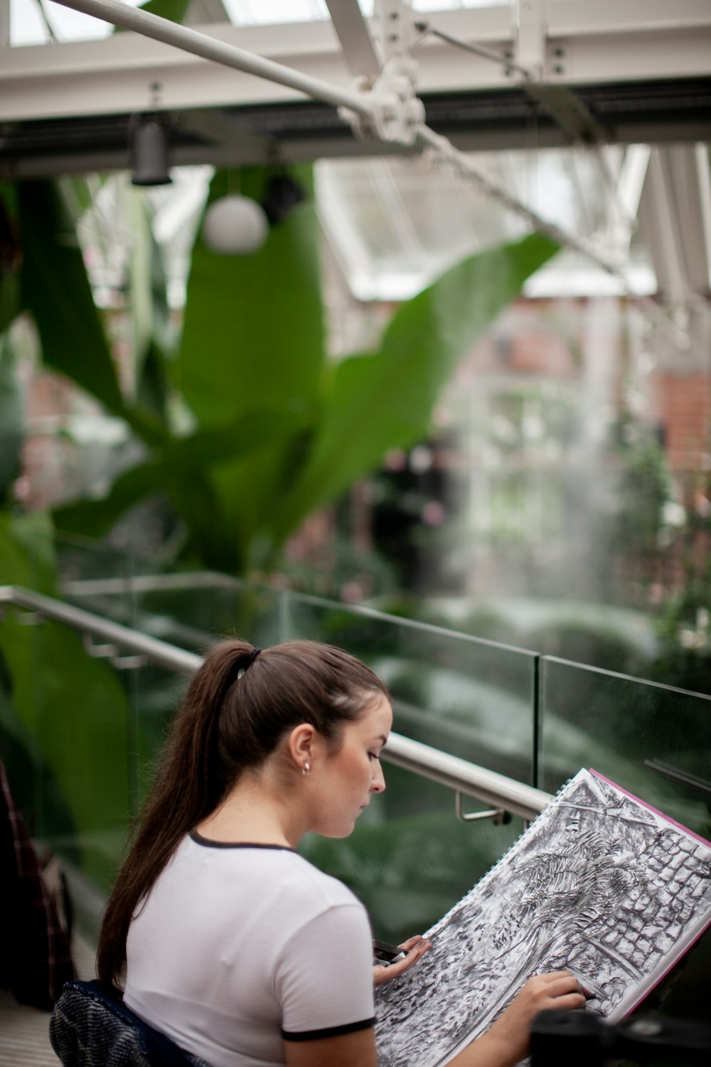 selective focus photography of woman sketching