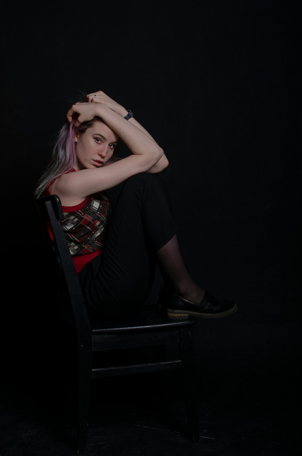 woman sitting on black wooden chair