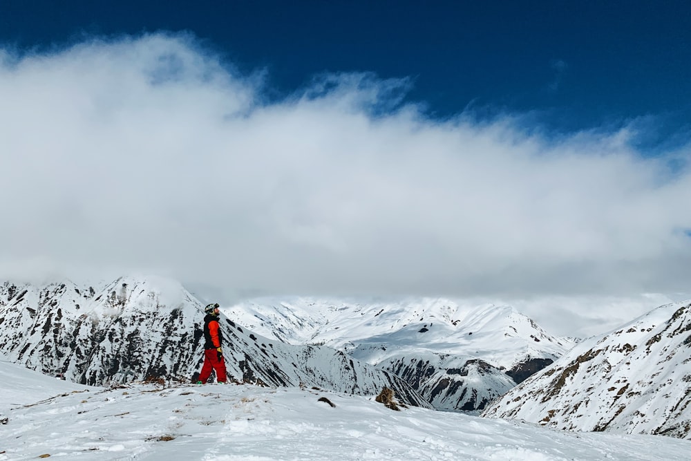 person wearing snow suit walking on snow field