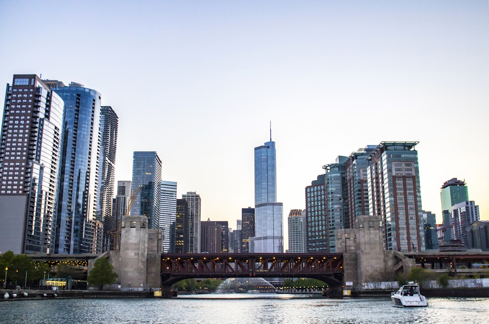 a boat traveling down a river next to tall buildings