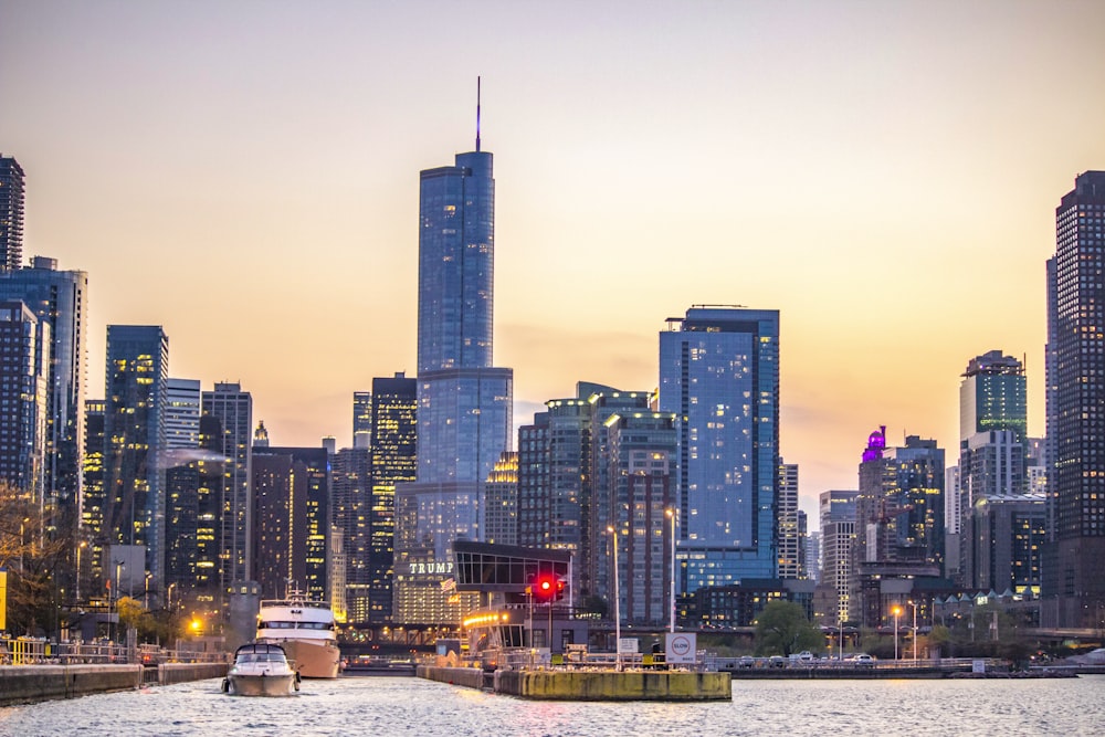 a boat is in the water in front of a large city