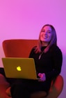 sitting woman while using MacBook
