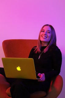 sitting woman while using MacBook