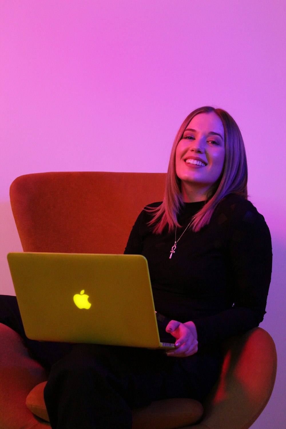 sitting woman while using MacBook