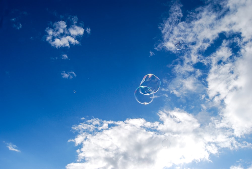 two bubbles under blue sky and white clouds during daytime