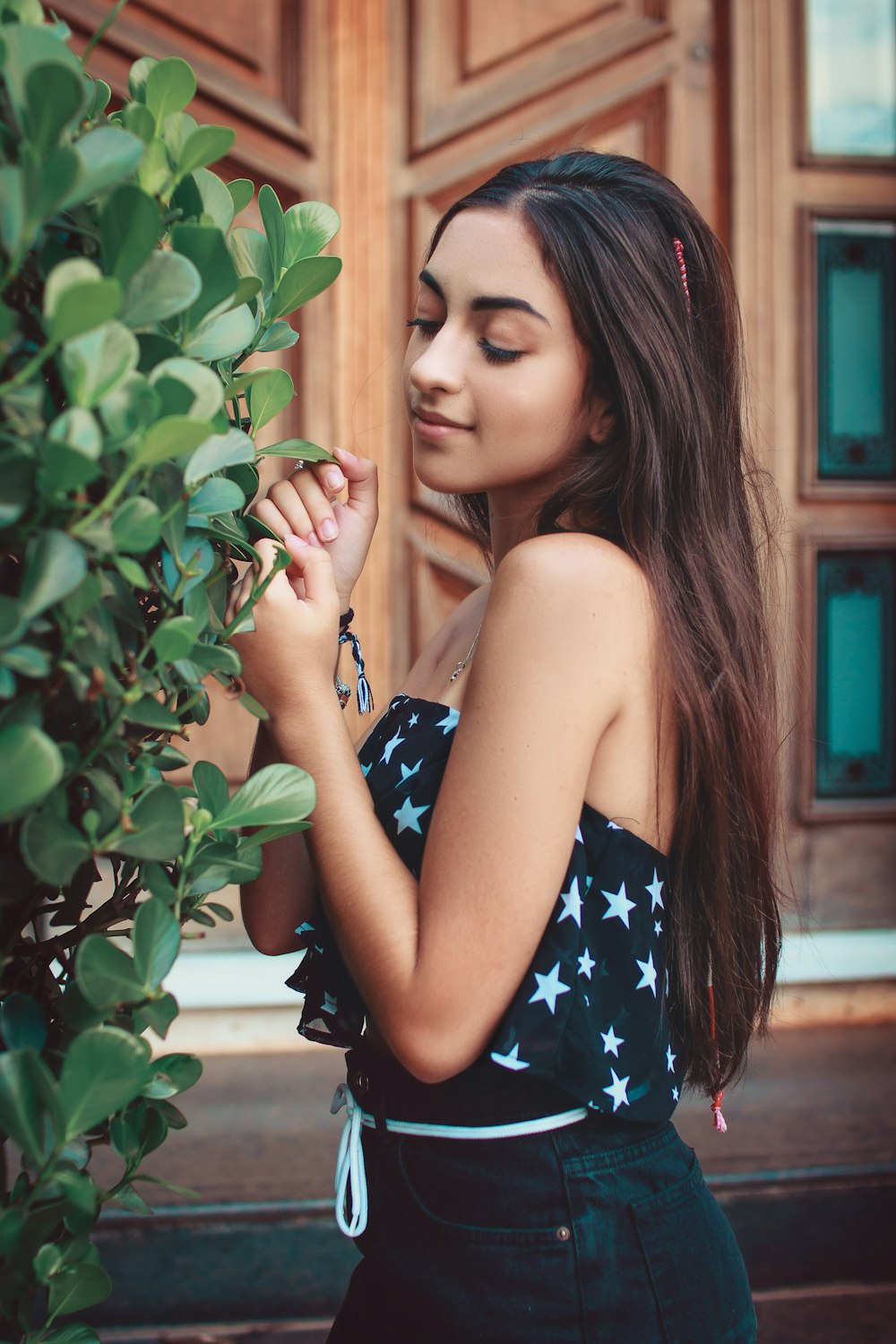 woman standing beside green-leafed plant