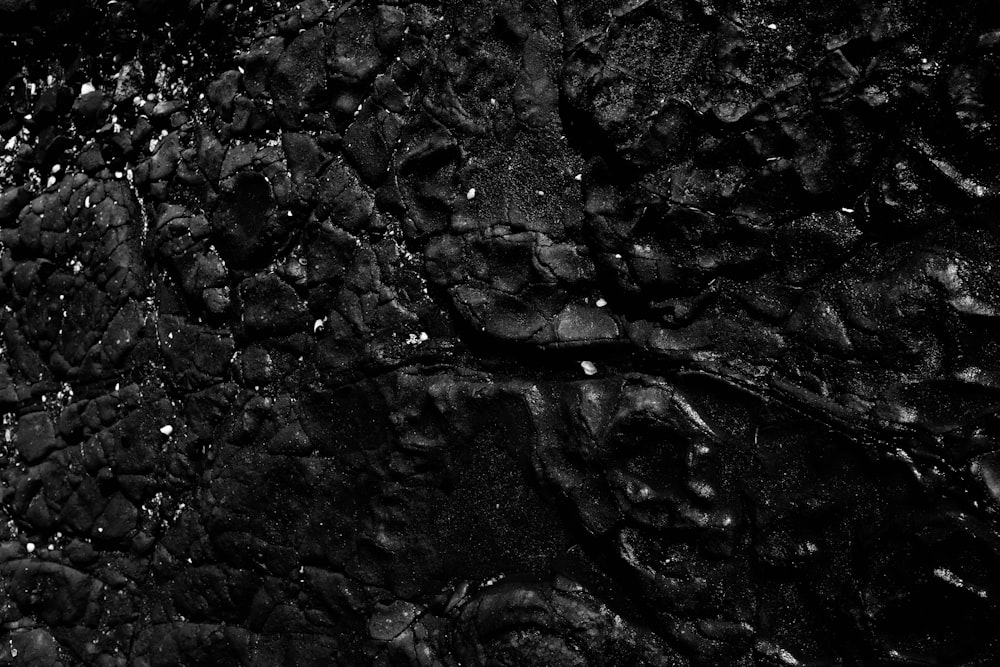 a black and white photo of rocks and water