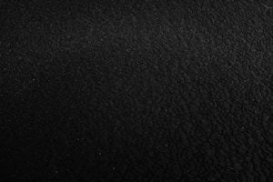 a black and white photo of a black surface