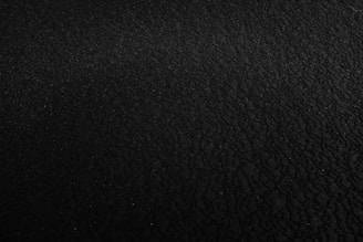 a black and white photo of a black surface