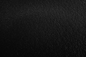 a black and white photo of a black surface