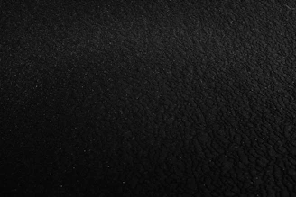 a black and white photo of a black surface