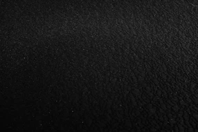 a black and white photo of a black surface